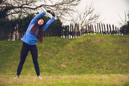 Young sporty girl warming up before exercise