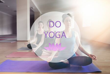 A group of young women doing yoga in the classroom. The concept of sports, meditation and yoga practice. Text DO YOGA
