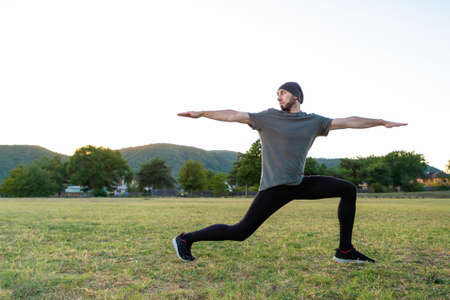 Sports and yoga. A man with a beard, in sportswear performs asana during yoga. Close up and copy space.の写真素材