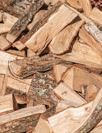 Preparation for the heating season. Chopped wood close-up. Brown colors. Background, texture. Vertical.の写真素材