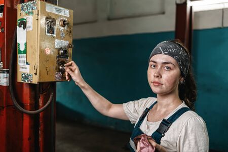 The concept of small business, feminism and womens equality. A young woman presses a button on the...