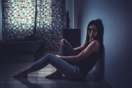 The concept of domestic violence. An exhausted Caucasian woman with beatings on her face and body...