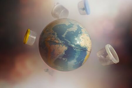Globe of Planet earth surrounded by plastic bottles and garbage.The concept of ecology and environmental pollution.の写真素材