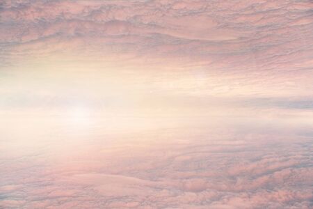 Pink homogeneous clouds at the sunset. Reflection. Fantasy pastel color.
