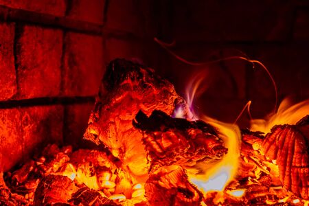Hot flame of fire in oven.smoldering coals close-up, bright, hot flame in the furnaceの写真素材