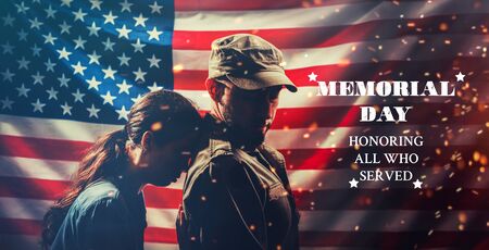 Memorial day. The woman puts her head on the soldier's back and he turns to her. Couple on the...
