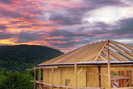 frame eco-friendly house on the background of mountains and forests at sunset.の写真素材