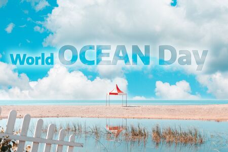 World ocean day. View of the sea coast with a single canopy. Blue cloudy sky. Text.の写真素材