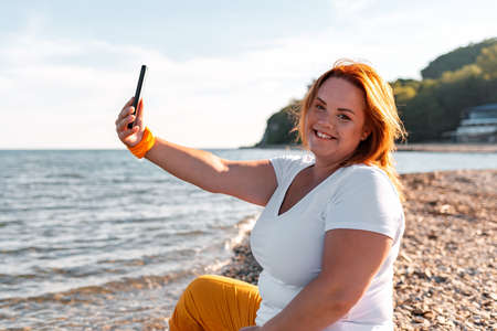 Preparation for school. A little Daughter hugs her mother from behind, who is holding a notebook in her hands. Upbringing and education of children.の写真素材