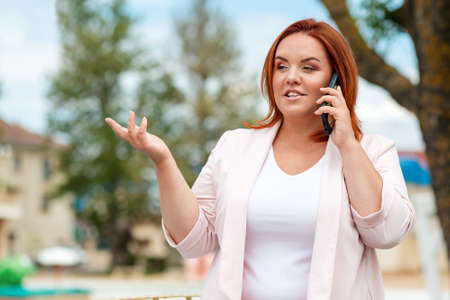 Preparation for school. A little Daughter hugs her mother from behind, who is holding a notebook in her hands. Upbringing and education of children.の写真素材