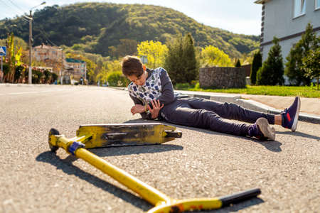 The concept of protection against viruses and diseases. Close-up portrait of a teenage boy in a blue t-shirt and mask. Yellow background. Copy space.の写真素材