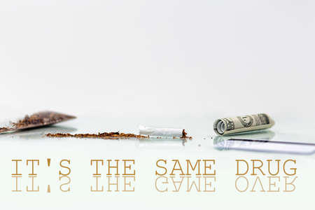 The concept of nicotine dependence and tobacco Smoking. On the glass table is a broken cigarette, a dollar bill with a tube, and a Bank card. White background. Copy space. The inscription It's the same drug.の写真素材