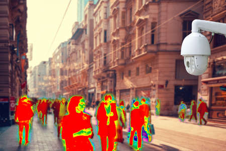 CCTV. Crowds of people walking down the street. Thermal imager filter. Concept of modern video surveillance technologies.の写真素材