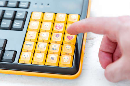 A males hand presses a button with a heart sign on the keyboard. Close up. Copy space. Concept of...