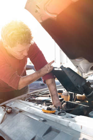 The concept of disability of people and their adaptation to life. Blond disabled man repairs the...