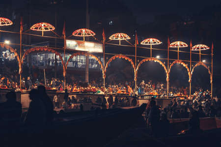 12/18/2019, Varanasi, India. Sacred religious ceremony of the Indians religion. Night, crowd of people. Arches with umbrellas decoration.のeditorial素材
