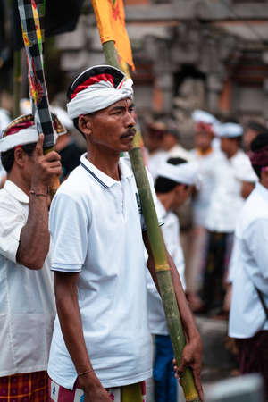 Galungan Holiday. A man in white clothes at the parade. Bali Island, Indonesia. 12/26/2018.のeditorial素材