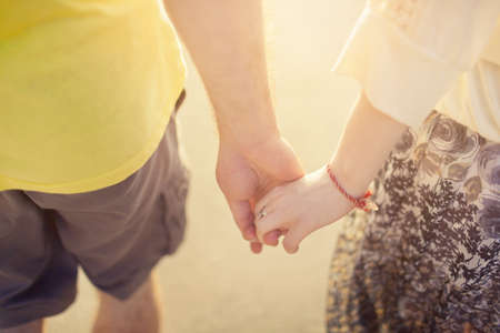 couple in love holding hands in sunlight .close up.の写真素材