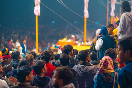 12/17/2019, Varanasi, India. a crowd of people watch and participate in an indian religious ceremony...