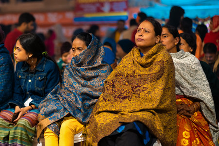 12/17/2019, Varanasi, India. The sacred religious ceremony of Arati. A group of women sits and watches a religious action.のeditorial素材