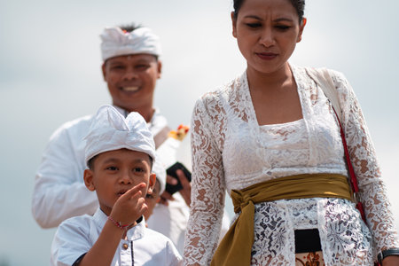 12/26/2018, bali, indonesia. Mother and child walk together by the hand. Traditional balinese family. Close-up portrait.のeditorial素材