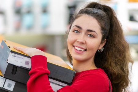 Close-up portrait of a young smiling woman holding a lot of boxes. The concept of shopping and...