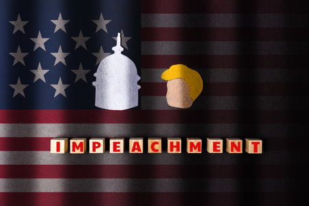 A cut out of portrait of the former president of America and the Capitol on a americans flag background. Wooden cubes with word ex-president. Black stripes like prison grate. Flat lay. The concept of impeachment.の写真素材