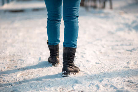 Female legs close up, rear view. The snow in the background. Copy space.の写真素材