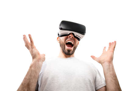 The concept of virtual reality. A wondered man in virtual reality glasses, with his mouth slightly...