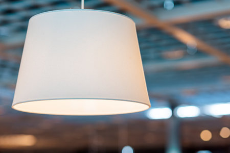 Close-up of a luminous light-colored hanging lamp.