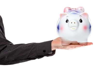 Saving money. A man's hand holds a piggy Bank on a white background. Isolate. Concept of business, Finance and economy.の写真素材