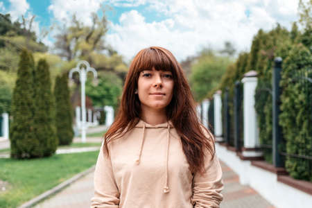 Portrait of a young caucasian woman posing at the street. The concept of successful confident...