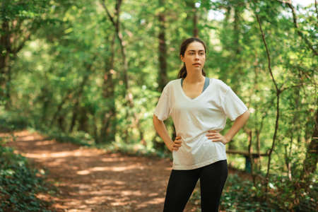 Portrait of woman relax after training at summer forest. The concept of cross-country running.の写真素材