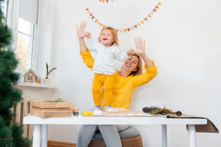 Happy mother and her child play together. Christmas preparations for the holidays.の写真素材
