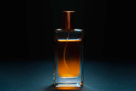 Close up of glass bottle of male perfume on dark background. Style perfumery template.の写真素材