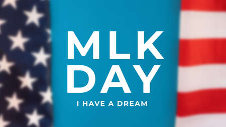 Blurred American Flag with abbreviation MLK. Happy Martin Luther King Day concept.の写真素材