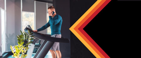 Banner with copy space. A sporty man trains on a treadmill and makes phone calls. The concept of modern communication and sports.の写真素材