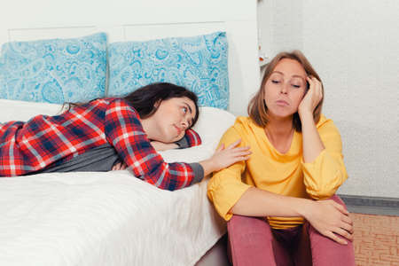 The concept of lesbian relationships. Two young women spend time next to each other. One woman comforts another, sadness and emotion.の写真素材