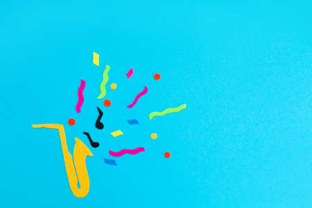 festival and holiday. A cutted out of felt saxophone on a blue background. flat lay. International Jazz Day. copyspace.の写真素材
