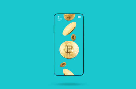 Close up of cell phone with bitcoins in screen. Turquoise background. copyspace. Concept of...