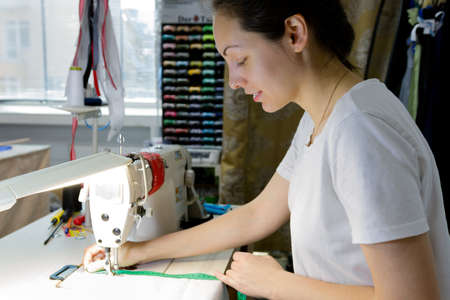 the seamstress working at the sewing machine.