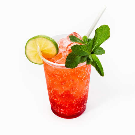 Cool delicious strawberry mojito cocktail decorated with mint and a slice of lime. Close up, on a white background. Mock up.の写真素材