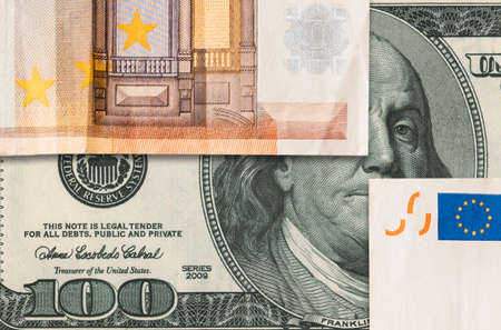 stock exchange. Euro banknotes covers portrait of Benjamin Franklin's at dollar paper currency. flat lay. The concept of the global crisis, investment and banking.の写真素材