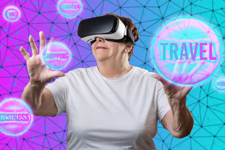 metaverse. Caucasian smiling elder woman in VR glasses choosing digital spheres with interests. Neon...