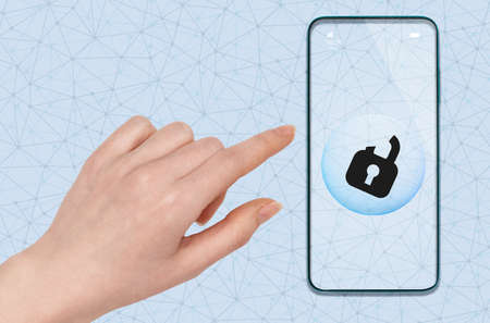 A woman's hand reaches for the phone to unlock the screen with a fingerprint. close-up. The concept...