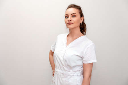 Portrait of adult confident woman at white backgound. Specialistの写真素材