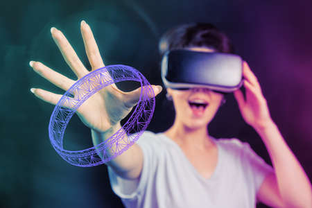 Contemporary art collage of defocused portrait of young happy woman in VR glasses takes a virtual...
