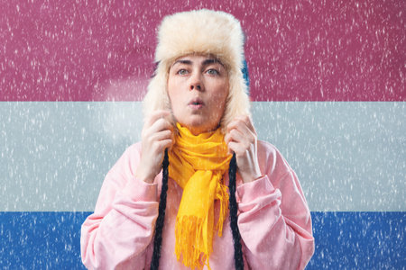 The energy crisis in Europe. A Dutch woman in a hat and scarf is breathing and coughing. In the...