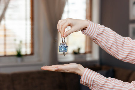 Purchase of real estate. Realtor shows keychain and keyring. close up of hands. Concept of leasing,...