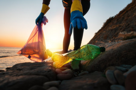 Conservation of ecology and garbage cleanup for recycling. Woman teer take a plastic bottle at the...